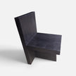 Three-quarter view of the Bespoke Butterfly Joint Fire-Charred Chair designed from premium teak wood planks highlighting its bold geometric brutalist form from Senja Living.