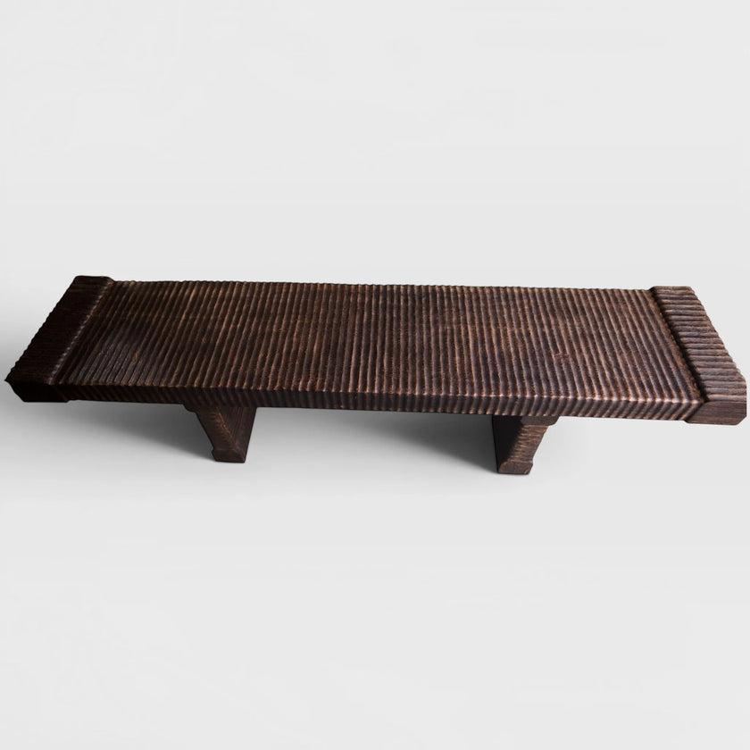 Hand-carved solid mango wood bench featuring a dark charred espresso finish and deep ridged sculptural textures.