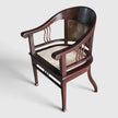 High-angle view of the Colonial Art Deco Teak Tub Back Armchair by Senja Living, showing the hand-woven cane seat and curved teak frame.