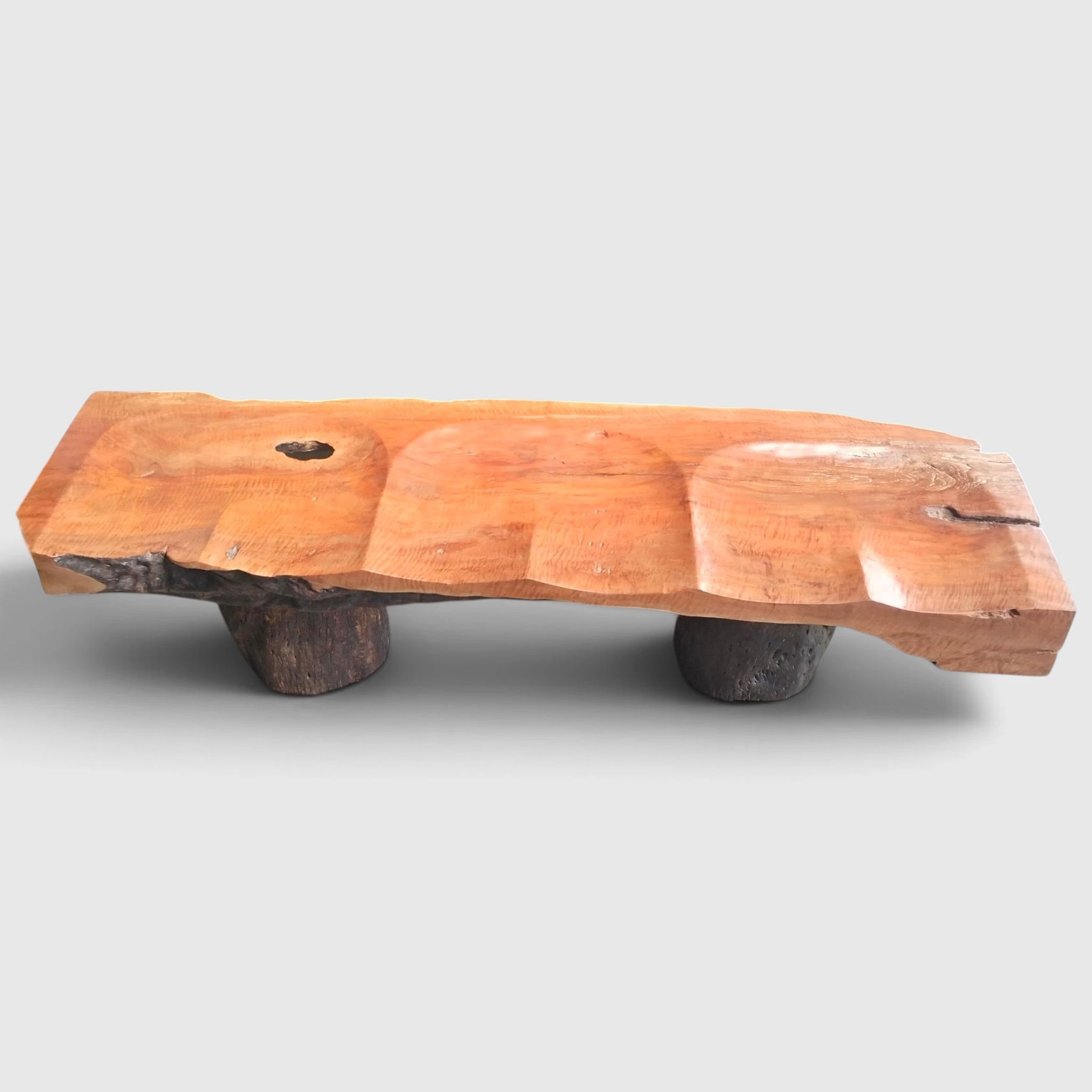 Senja modern organic bench crafted from solid carved lychee wood featuring sculptural scalloped seating and monolithic natural log pillars for luxury minimalist interiors.