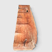 Top-down view of Senja modern organic bench showcasing the natural live-edge slab silhouette and rich swirling grain of the carved lychee wood.