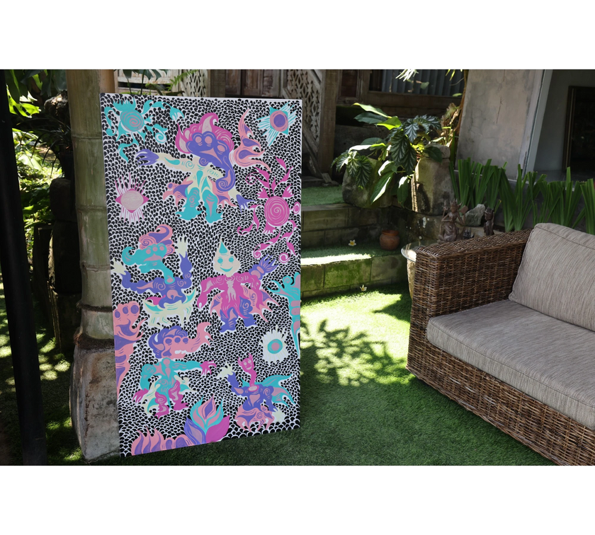 Keep Smiling (2026), an original painting by emerging Balinese artist I Made Ananda Krisna, displayed outdoors on his family’s art gallery property in Bali, beside a traditional stone structure and garden seating — curated and photographed by Senja Living.