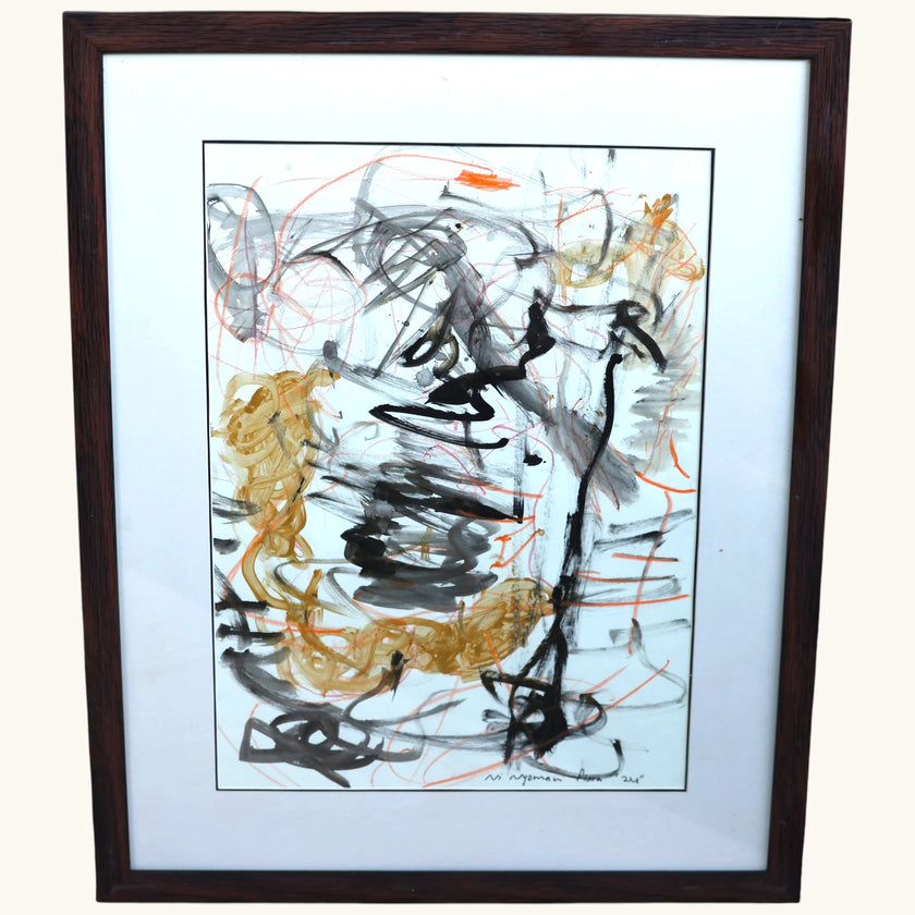 Closer view of Naga (2024), an original acrylic painting on paper by talented young emerging Balinese artist Ni Nyoman Aura Komala Dewi, showing expressive black and charcoal brushstrokes, looping ochre forms and fine vermilion lines within its dark wood frame and white mat — photographed and curated by Senja Living.