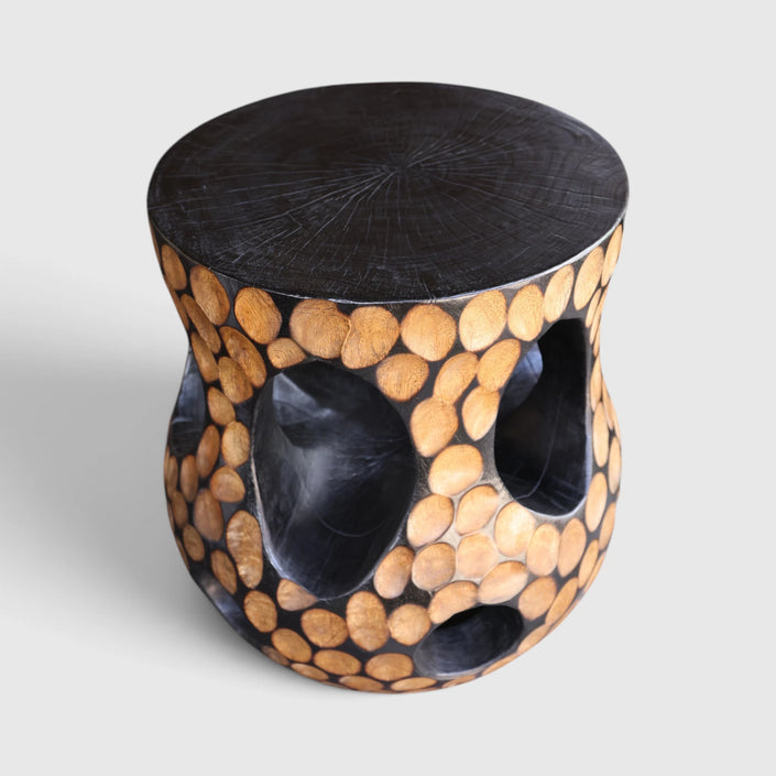 Sculpted charred mango accent table, a singular, beautiful statement piece for artful living.