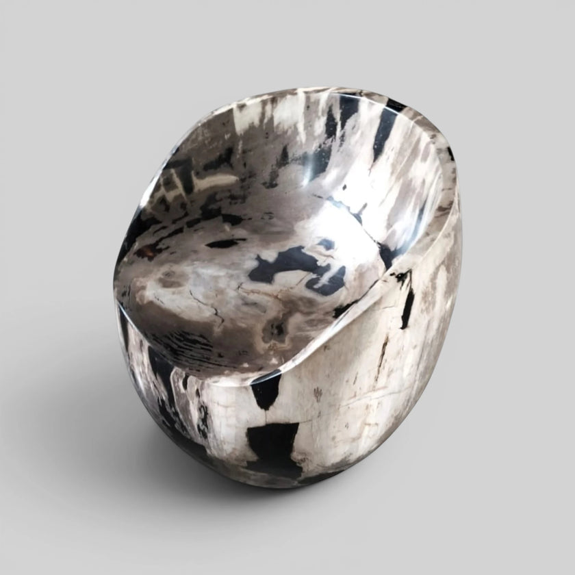 Polished scoop seat of the Black and White Crystalline Petrified Wood Accent Chair showcasing natural organic stone quartz patterns from Senja Living.