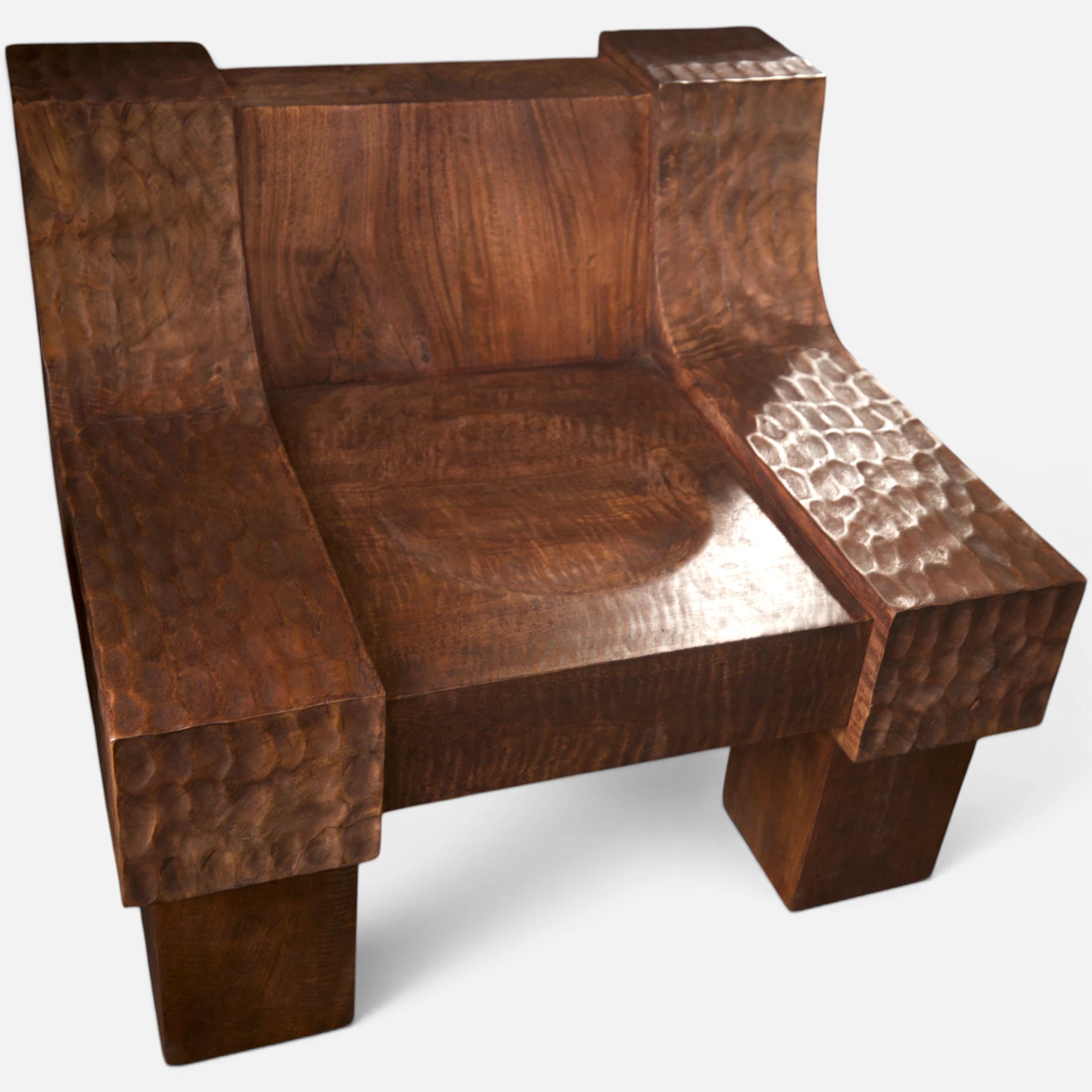 Hero close-up macro view of the modern organic brutalist lounge chair No.99, featuring its signature polished hand-chiseled dimpled textures and scooped seat with smooth backrest. Senja Living —where furniture becomes art.