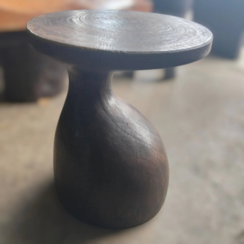 Showroom view of the Sculptural Gooseneck Espresso Side Table styled inside a modern luxury lounge interior setting from Senja Living.