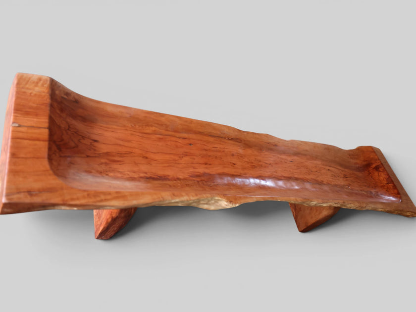An elevated aerial back view of the Sculptural Live Edge Bench by Senja Living, highlighting the rugged textured live edge and the beautifully polished interior seating surface.