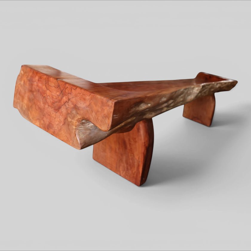 An angled back view of the Sculptural Live Edge Bench by Senja Living, highlighting the full length of the beautifully polished outer surfaces and the wonderfully designed wedge blocks.