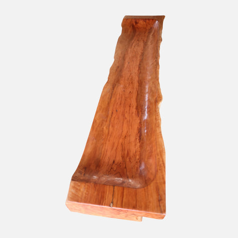 An overhead perspective of the Sculptural Live Edge Bench by Senja Living, highlighting the beautifully contoured seating surface and fiery natural lychee wood grain patterns.