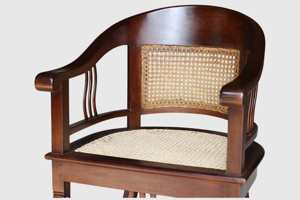 Close up detail of the hand-woven natural cane paneling and solid teak wood frame on the Colonial Art Deco Tub Back Armchair by Senja Living.