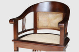 Close up detail of the hand-woven natural cane paneling and solid teak wood frame on the Colonial Art Deco Tub Back Armchair by Senja Living.
