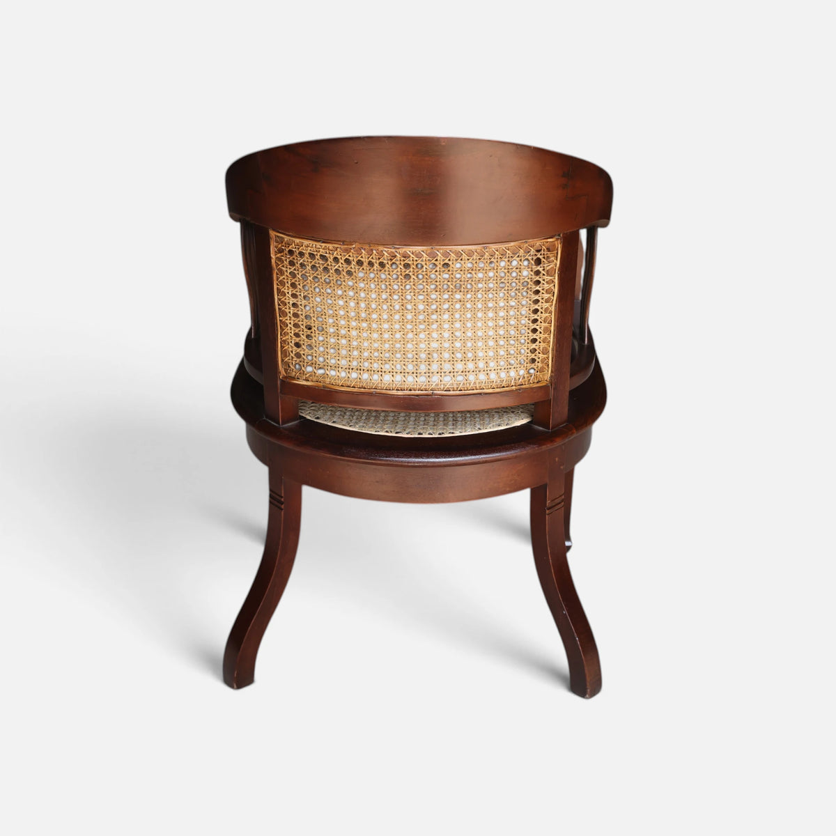 Rear view of the Colonial Art Deco Teak Tub Back Armchair by Senja Living, showing the curved solid teak back rail and hand-woven cane paneling.