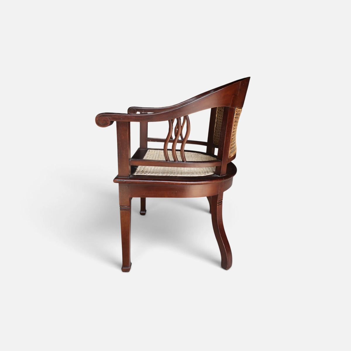 Wide side profile of the Colonial Art Deco Teak Tub Back Armchair by Senja Living, emphasizing its sculptural silhouette and sweeping curved arms.