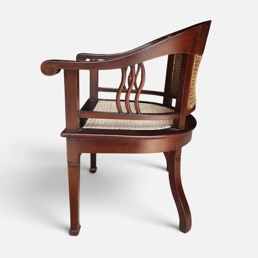 Side profile view of the Colonial Art Deco Teak Tub Back Armchair by Senja Living, highlighting the curved wood arms and undulating side splats.