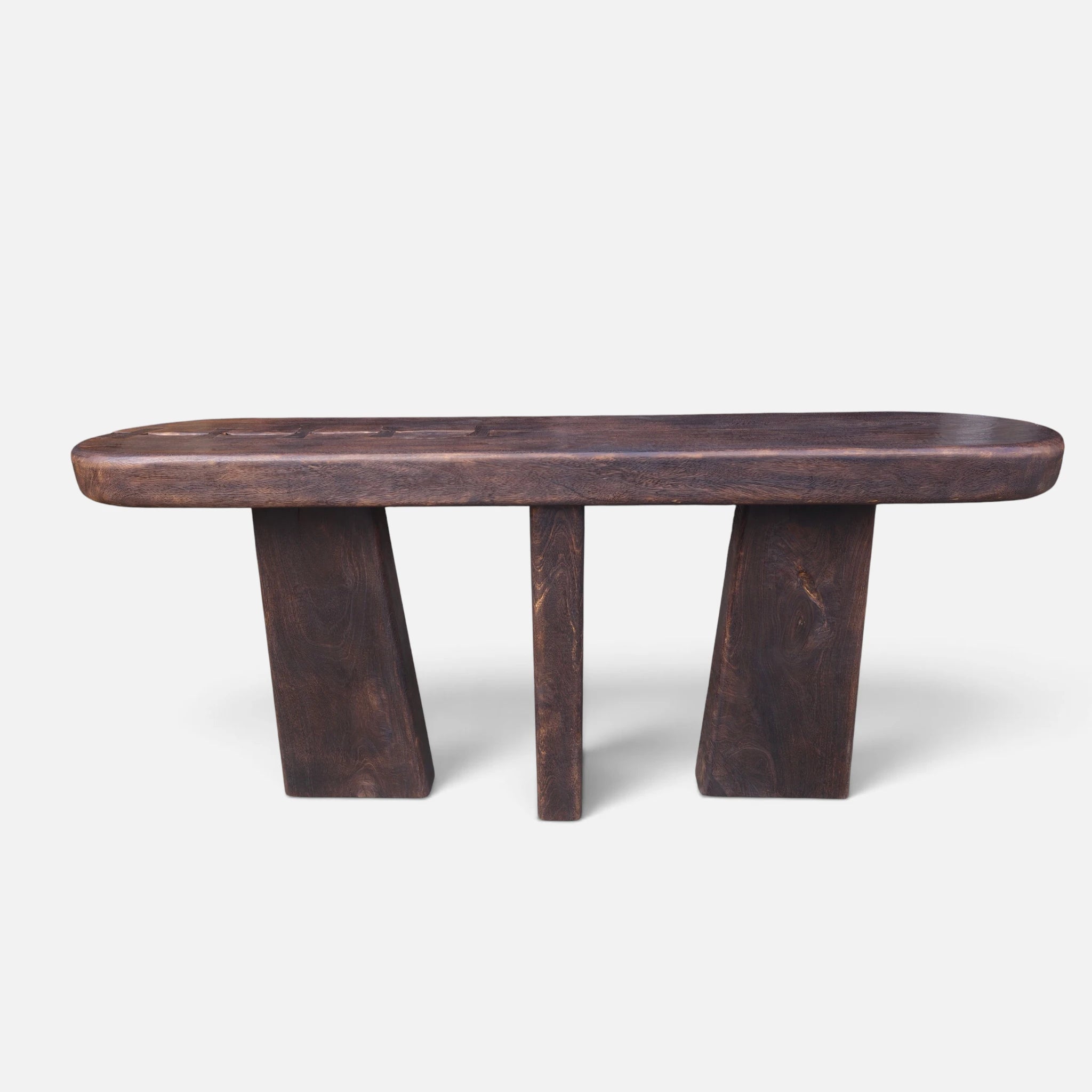 Full straight front-facing studio shot of the solid mango wood console table showing its three monumental block legs and fire-torched finish.