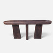 Full straight front-facing studio shot of the solid mango wood console table showing its three monumental block legs and fire-torched finish.