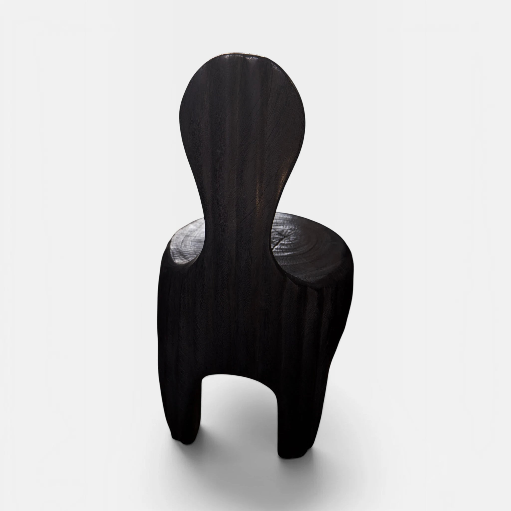 The Senja Living Bespoke Spoon-Back Chair is hand-sculpted from solid mango wood and is as commanding from the back as it is from the front.