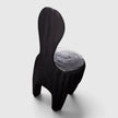 The Senja Living Bespoke Spoon-Back Chair is fire-torched from a single block of solid mango wood featuring a tall spoon-shaped backrest and a polished seat showing natural wood grain rings.