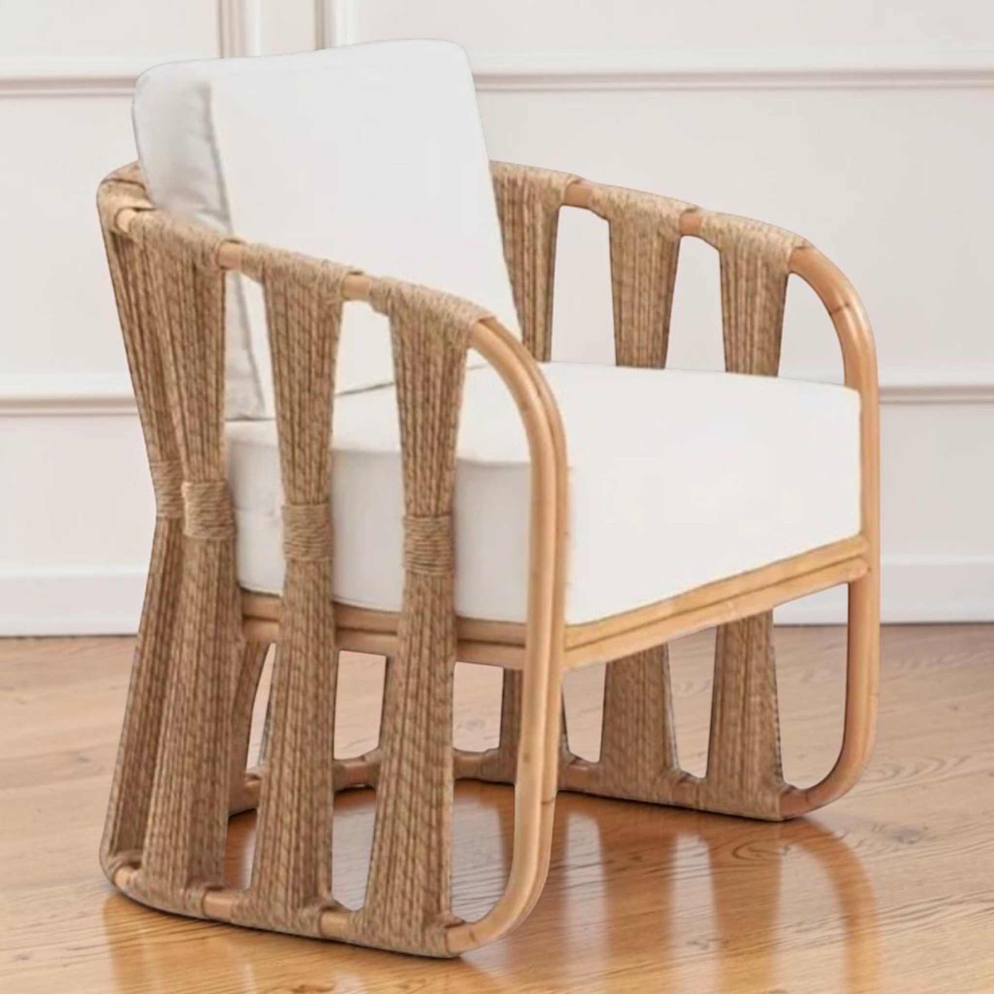  Studio-made Senja Ropes Attached Accent Chair highlighting the sweeping double-pole rattan frame and vertical weave rope detailing in a classic strings attached lounge chair style.