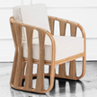 High-contrast lifestyle vignette of the Senja Ropes Attached Accent Chair showcasing the architectural shadow lines of the double-pole rattan frame in a strings attached lounge chair style.